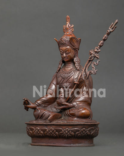 Guru Rinpoche side view showing hand carved robe and sacred ritual attributes.