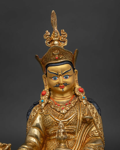 Guru rinpoche statue 24k gold face semi precious stones close up.