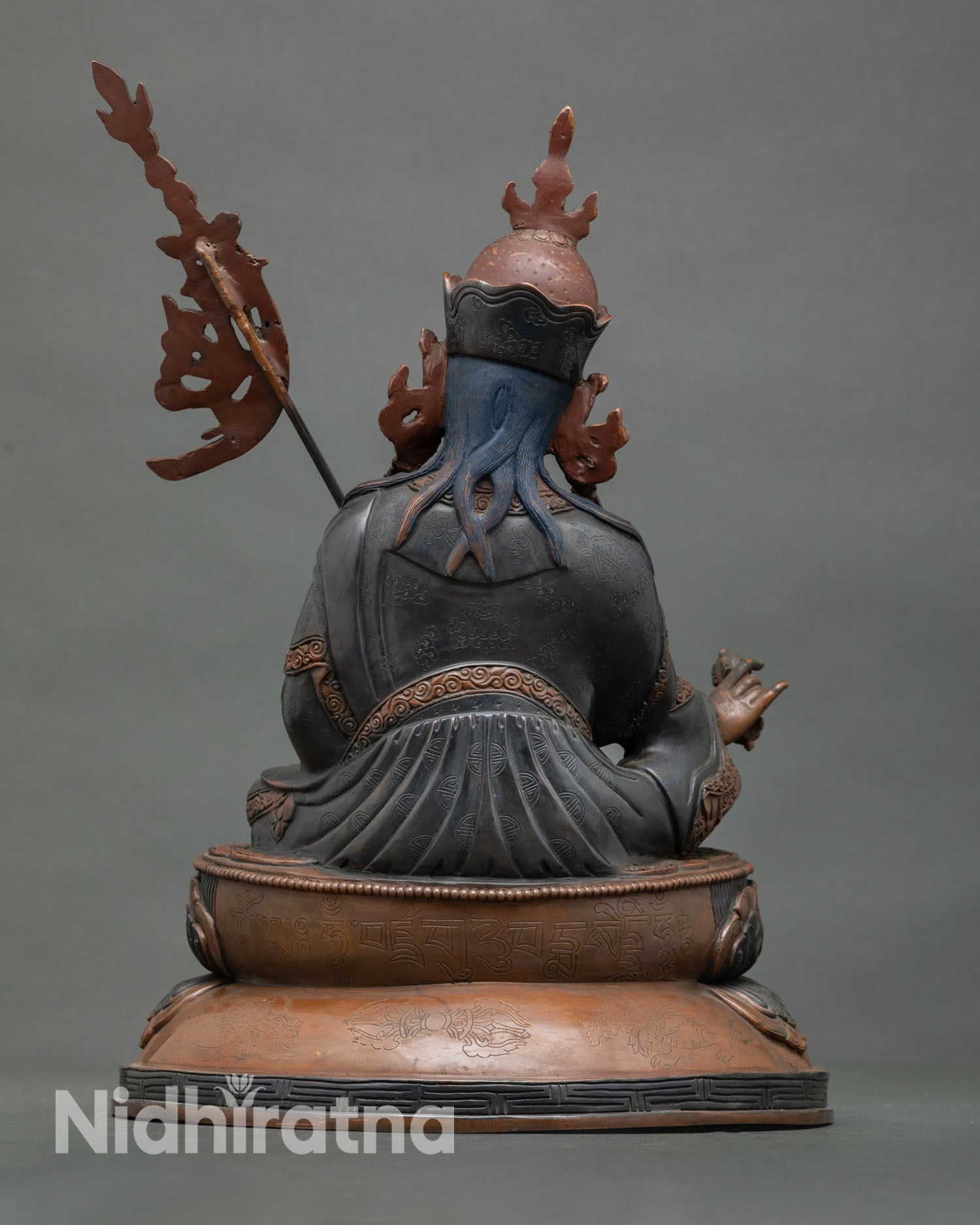 Guru Rinpoche statue back view Himalayan Buddhist sculpture lotus seat sacred altar decor Vajrayana art