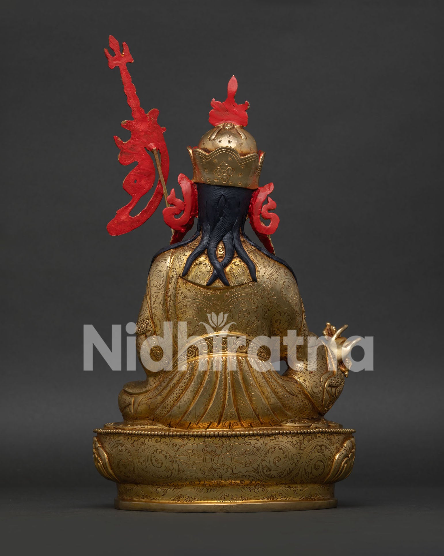 guru rinpoche statue back view showing lotus hat and ornate robes