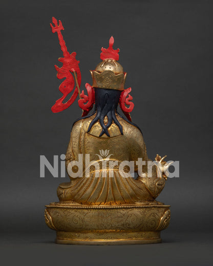 guru rinpoche statue back view showing lotus hat and ornate robes