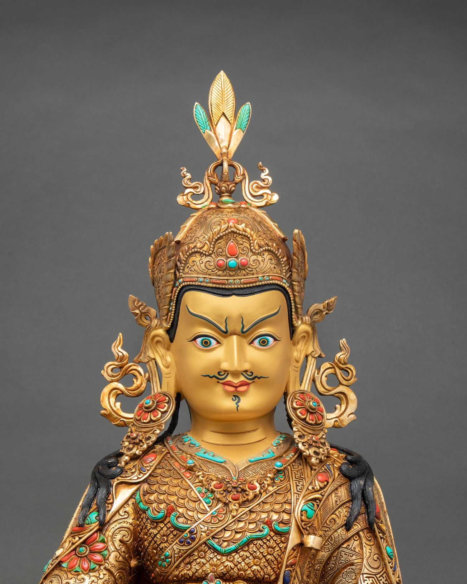 Guru Rinpoche statue close up gold painted face vajra detail Padmasambhava Tibetan Buddhist sacred art