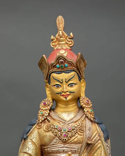 Guru Rinpoche statue close up view Padmasambhava serene expression vajra kalash sacred details Himalayan Buddhist art gold painted finish