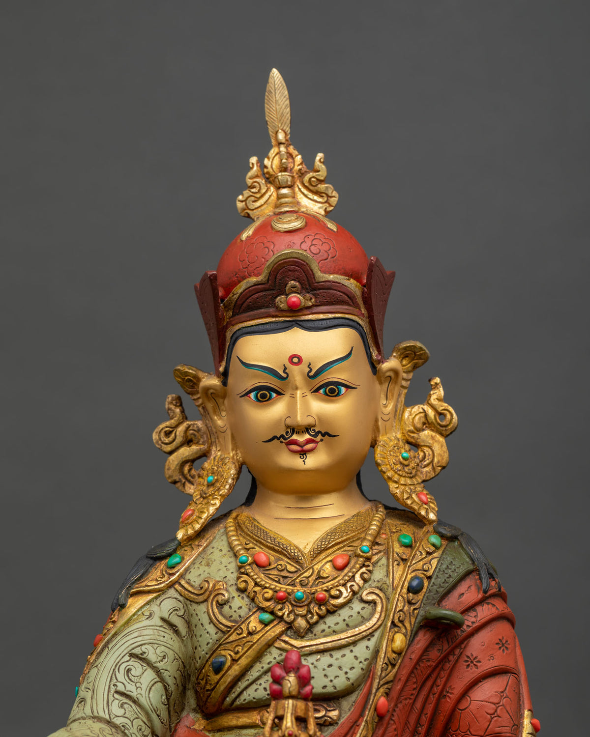 Guru Rinpoche Statue face close up 24K gold painted face acrylic details.