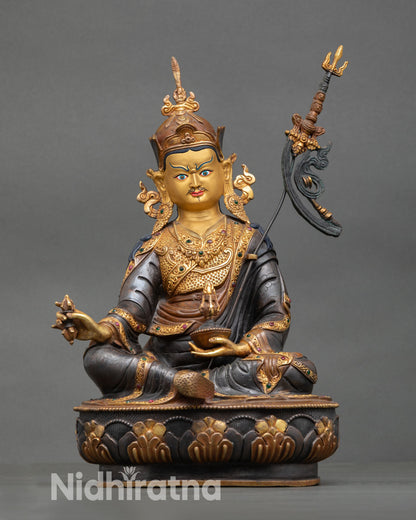 Guru Rinpoche statue front view Padmasambhava gold painted face oxidized copper lost wax casting lotus seat Nepal artisan sculpture