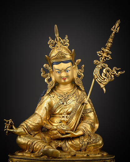 Guru Rinpoche statue gold fire gilded royal robes floral motifs.