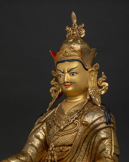 guru rinpoche statue gold painted face detailed side close up