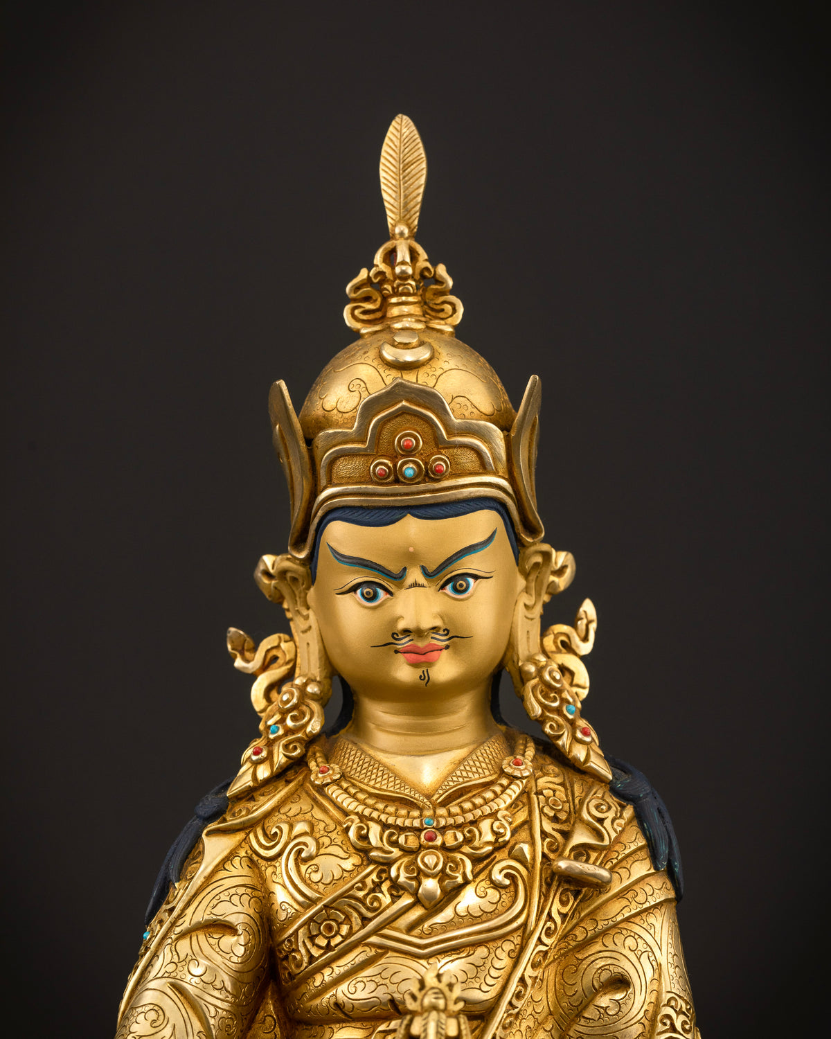Guru Rinpoche Statue with gold painted face inlaid semi precious stones and floral carvings