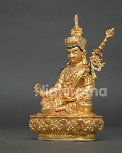 Guru rinpoche statue handcrafted in nepal with gold gilded copper body and lotus pedestal.