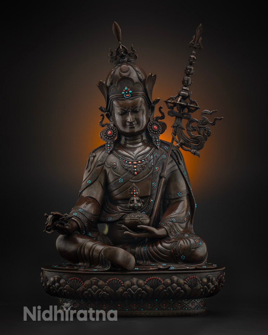 Guru Rinpoche statue in oxidized copper, front view with turquoise inlay