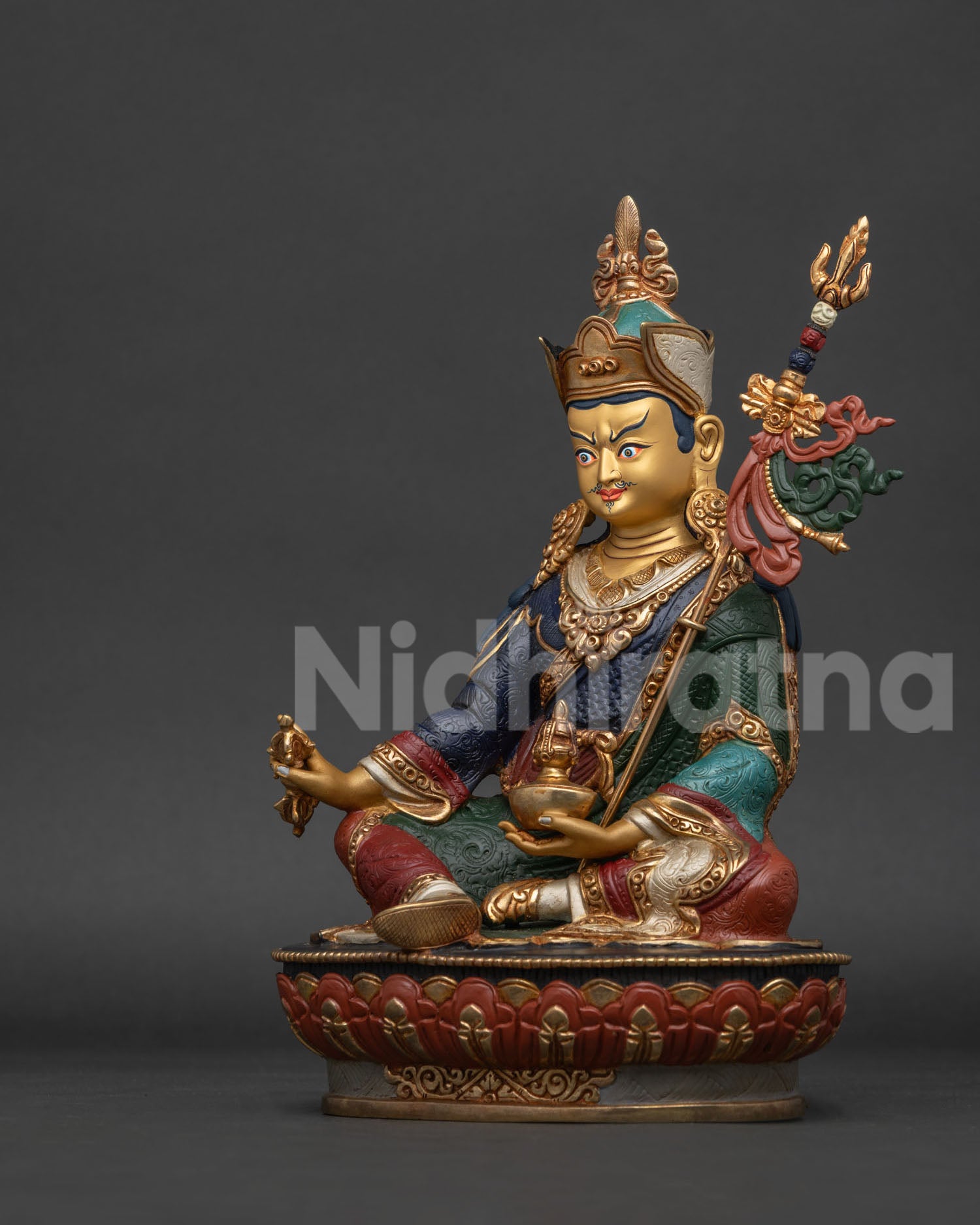 Guru Rinpoche statue left side view showing copper craftsmanship and sacred attributes