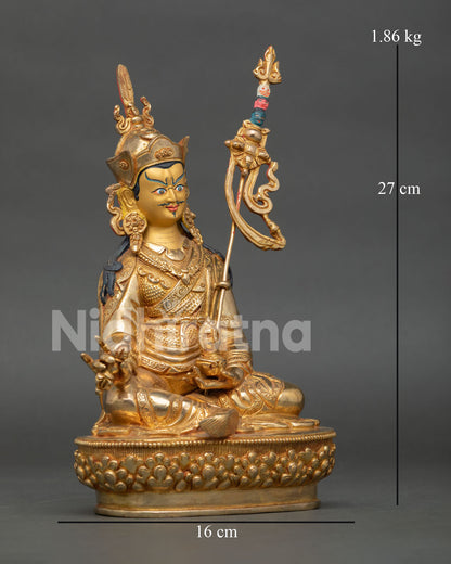 Guru Rinpoche statue on lotus pedestal holding vajra trident and skull cup with vase