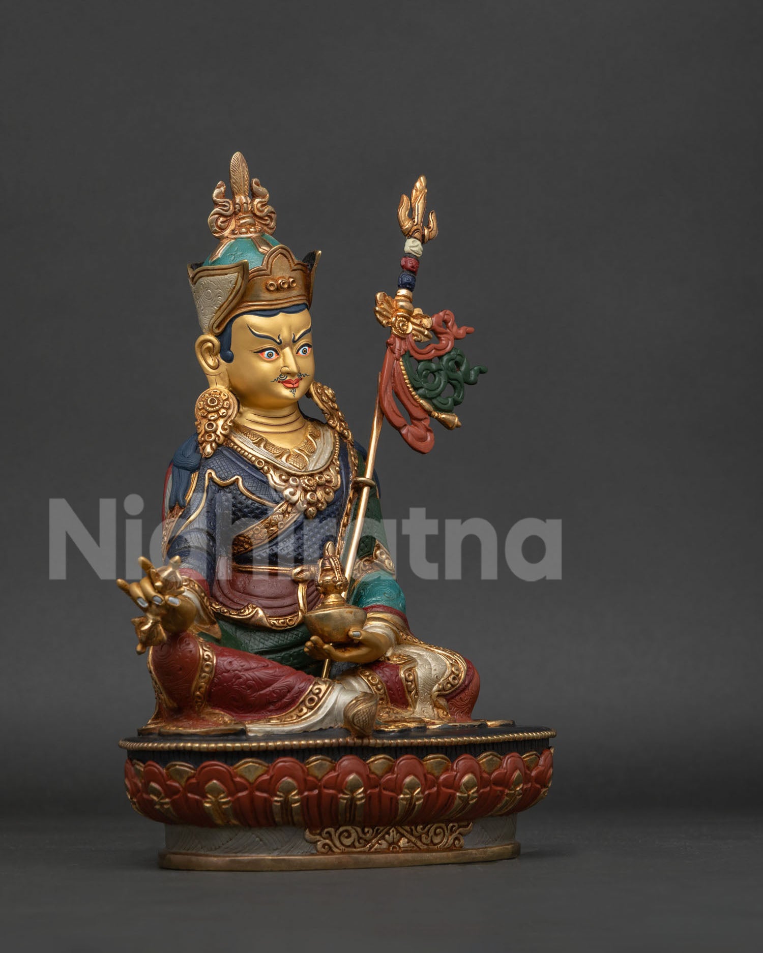 Guru Rinpoche statue right side view showing robes lotus pedestal and khatvanga