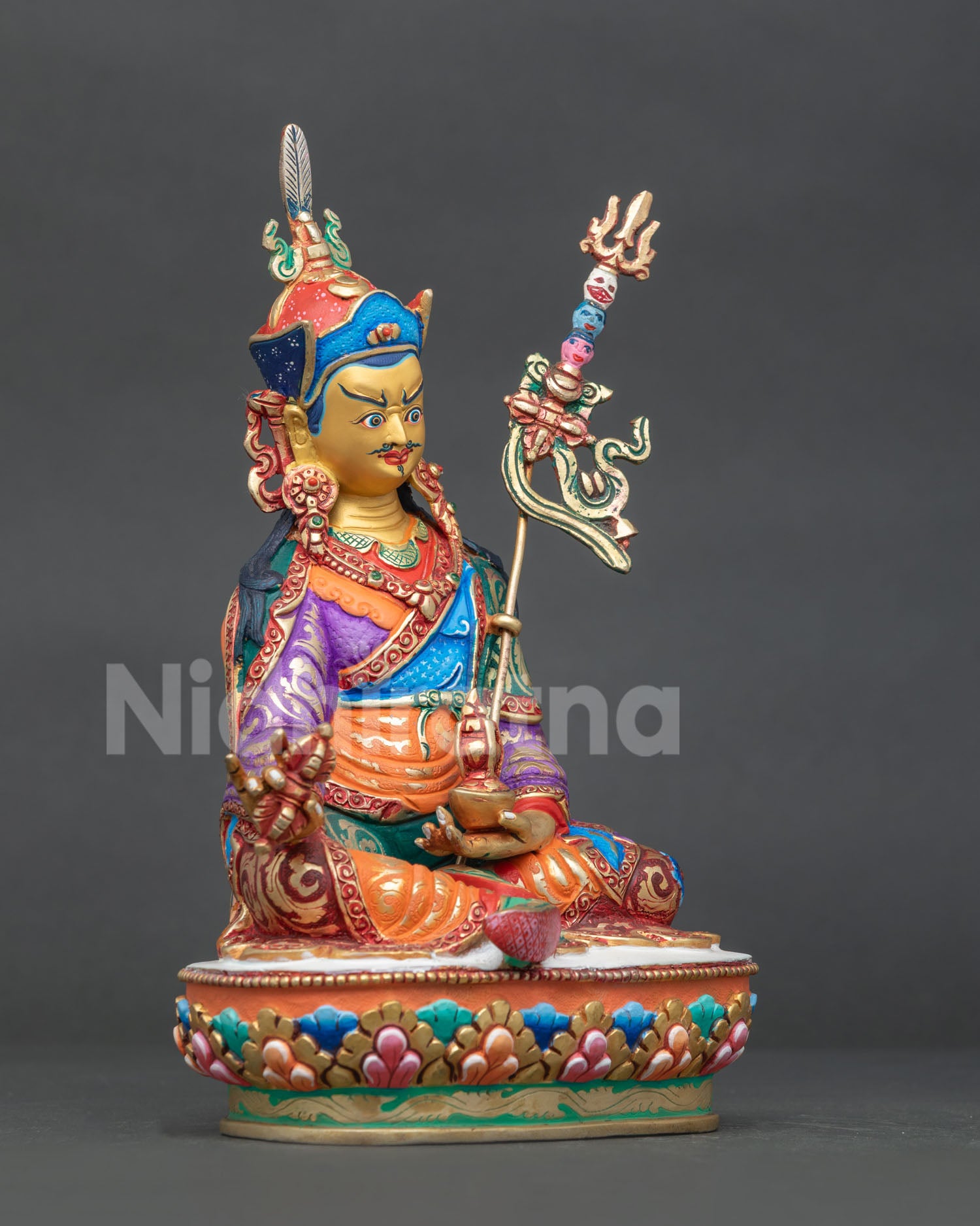 Guru Rinpoche statue right side view with vajra kapala and khatvanga trident.