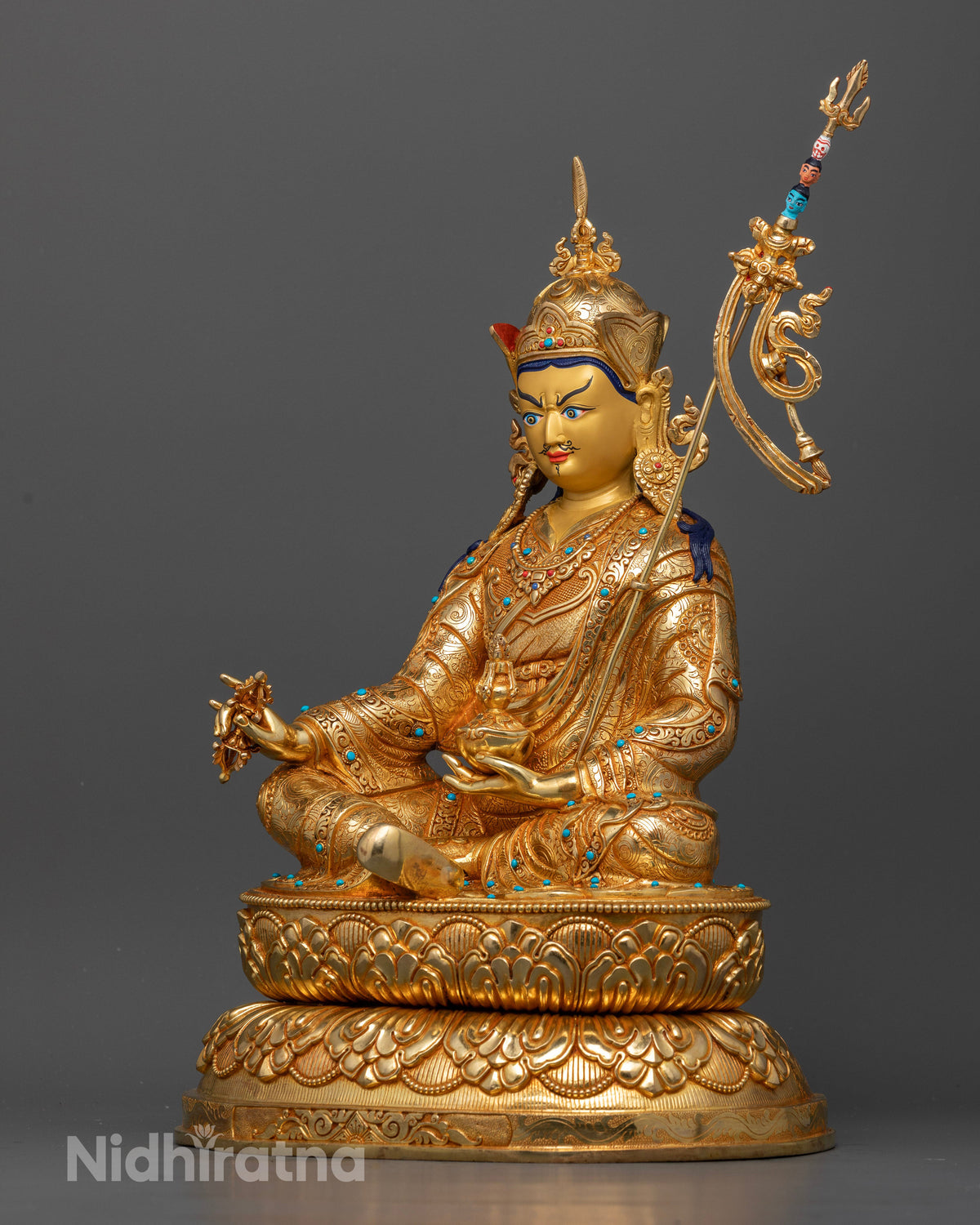 Guru Rinpoche statue seated on a hand-carved double lotus pedestal with semi-precious stones and ornate jewelry.