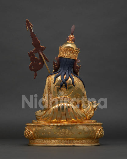 Guru Rinpoche statue showing Ashtamangala garment carving and vulture feather.