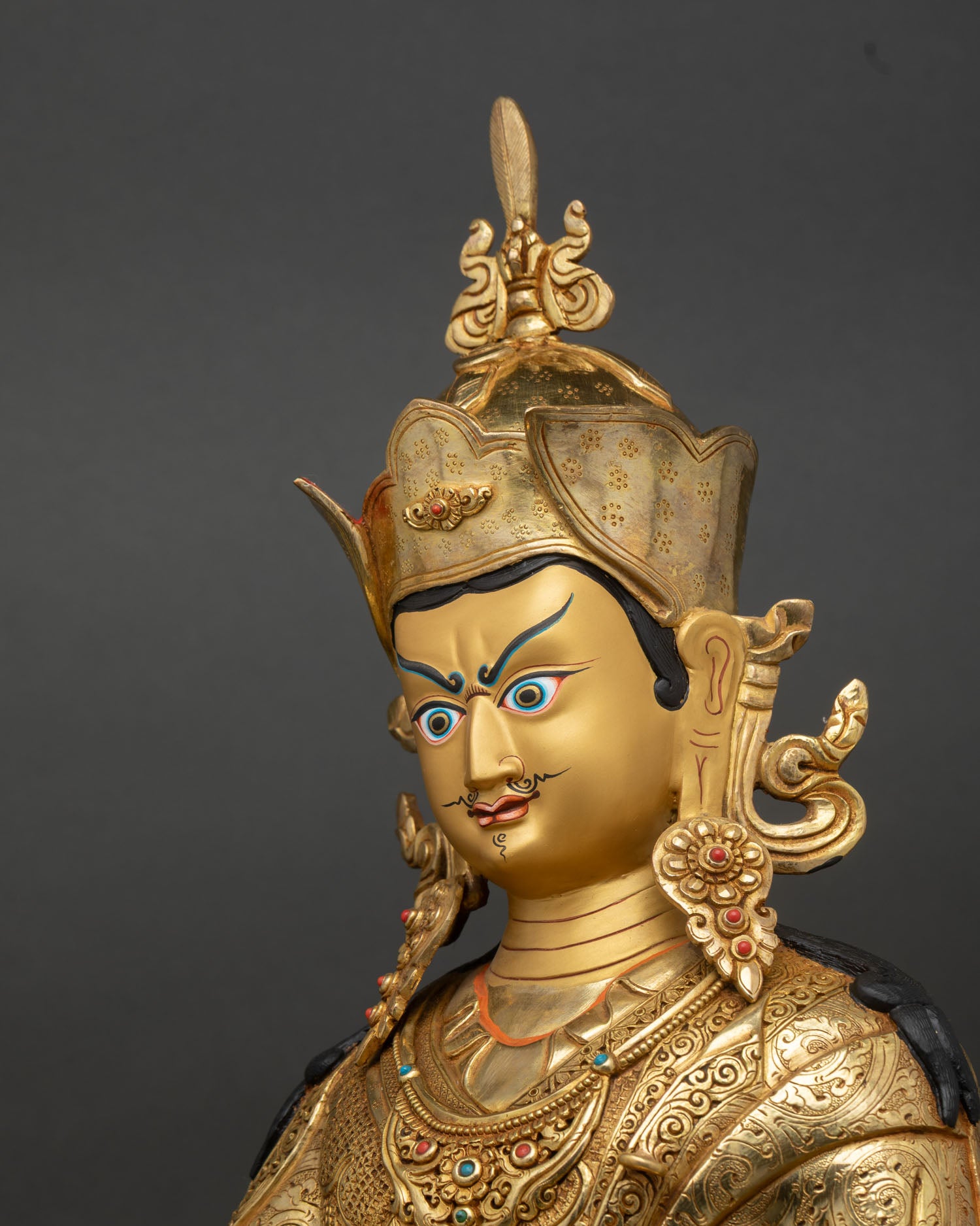 Guru Rinpoche Statue side detail close up lotus base vajra skull cup carving