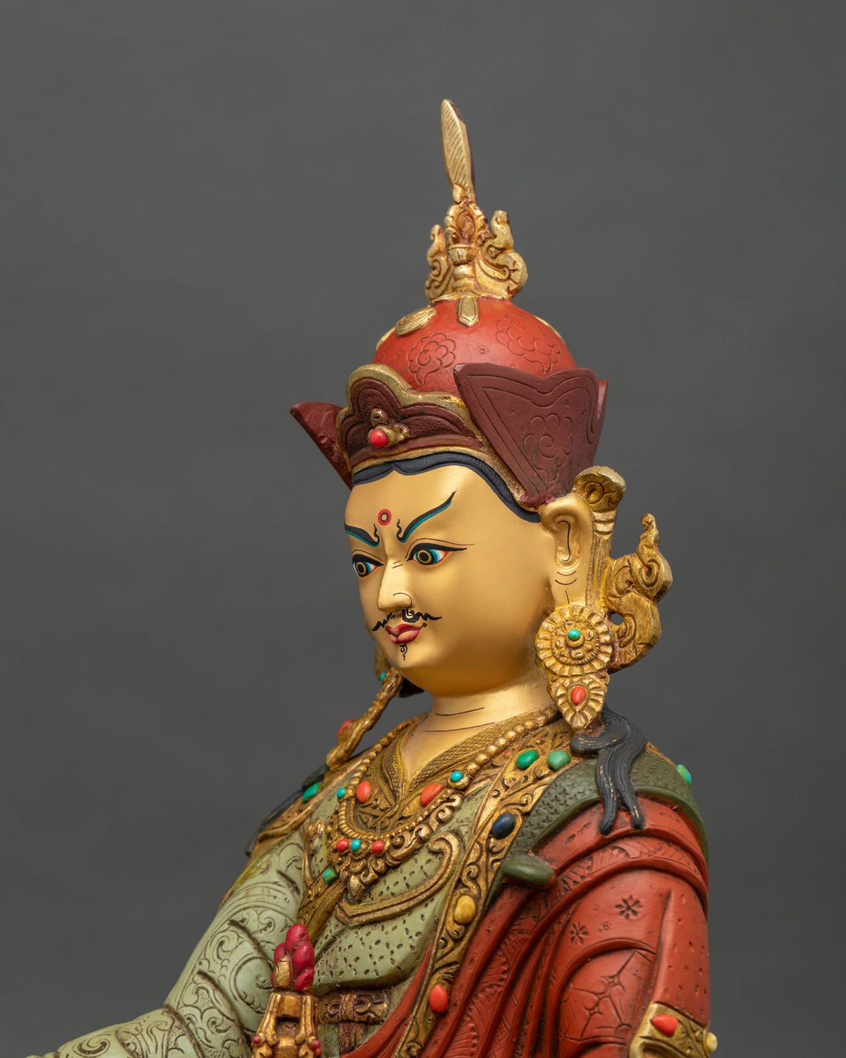 Guru Rinpoche Statue side face close up royal regalia floral carved details.