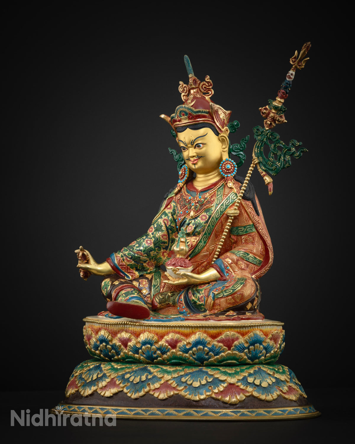 Guru Rinpoche statue side profile with khatvanga staff, gold fire-gilded with turquoise and coral