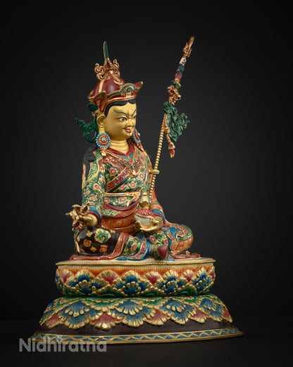 Guru Rinpoche statue side view holding vajra and kapala on double lotus pedestal, fire-gilded copper