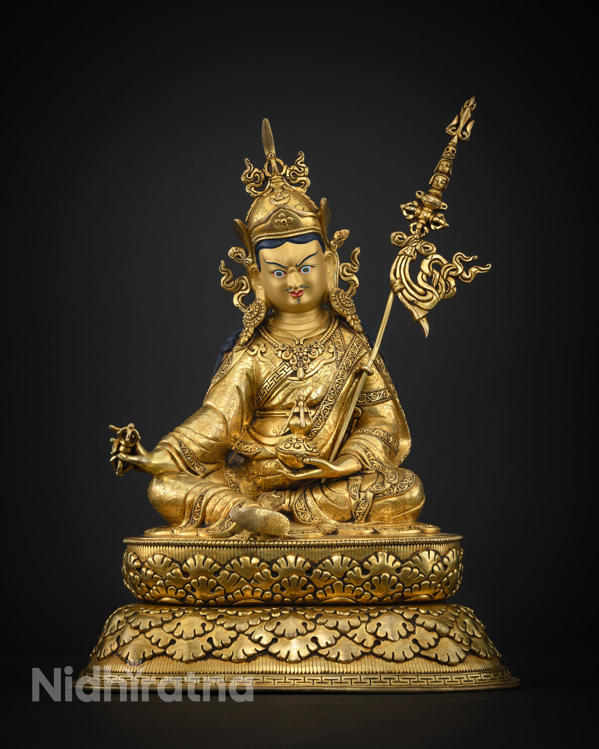 Guru Rinpoche statue skull cup and vase symbolic detail.