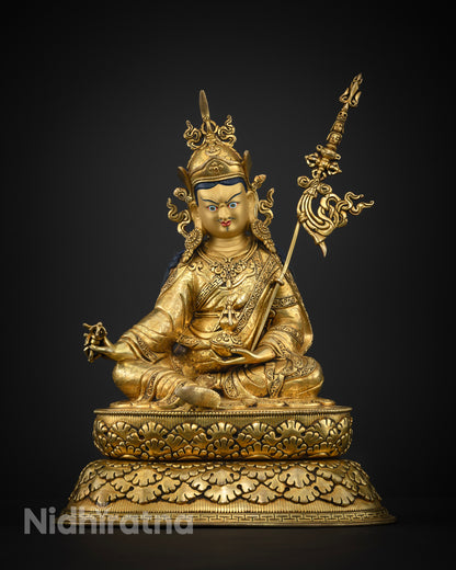 Guru Rinpoche statue skull cup and vase symbolic detail.