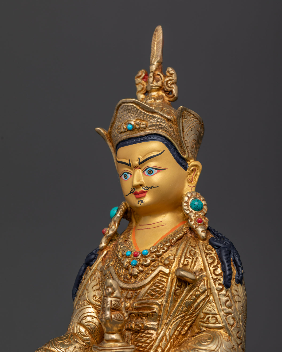 Guru Rinpoche statue with 24K gold painted face and semi precious stones.