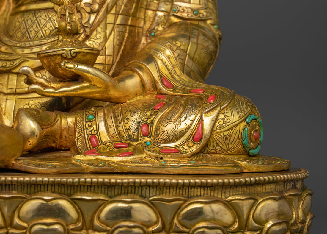 left leg of guru Padmasambhava statue with his left arm holding a skull cup with vase