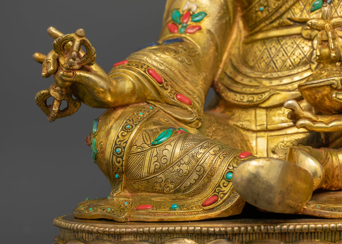 guru rinpoche statue holding the vajra on his right hand