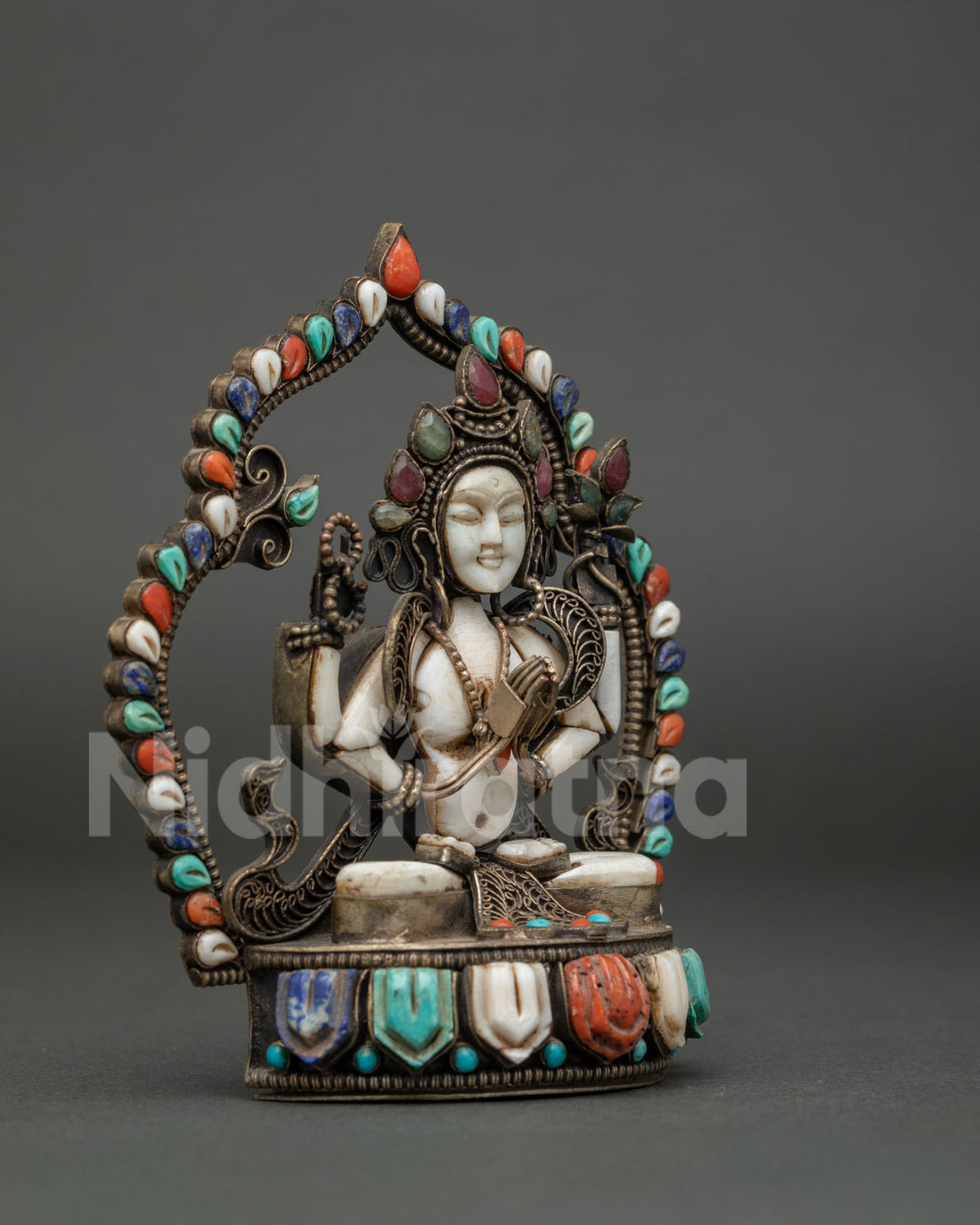 Hand-carved lotus pedestal inlaid with gemstones on a handmade Chenrezig statue from Nepal