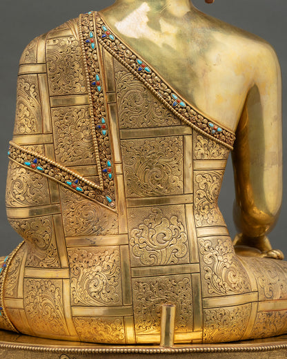 hand engraved robe detail of shakyamuni buddha statue with turquoise stone inlay