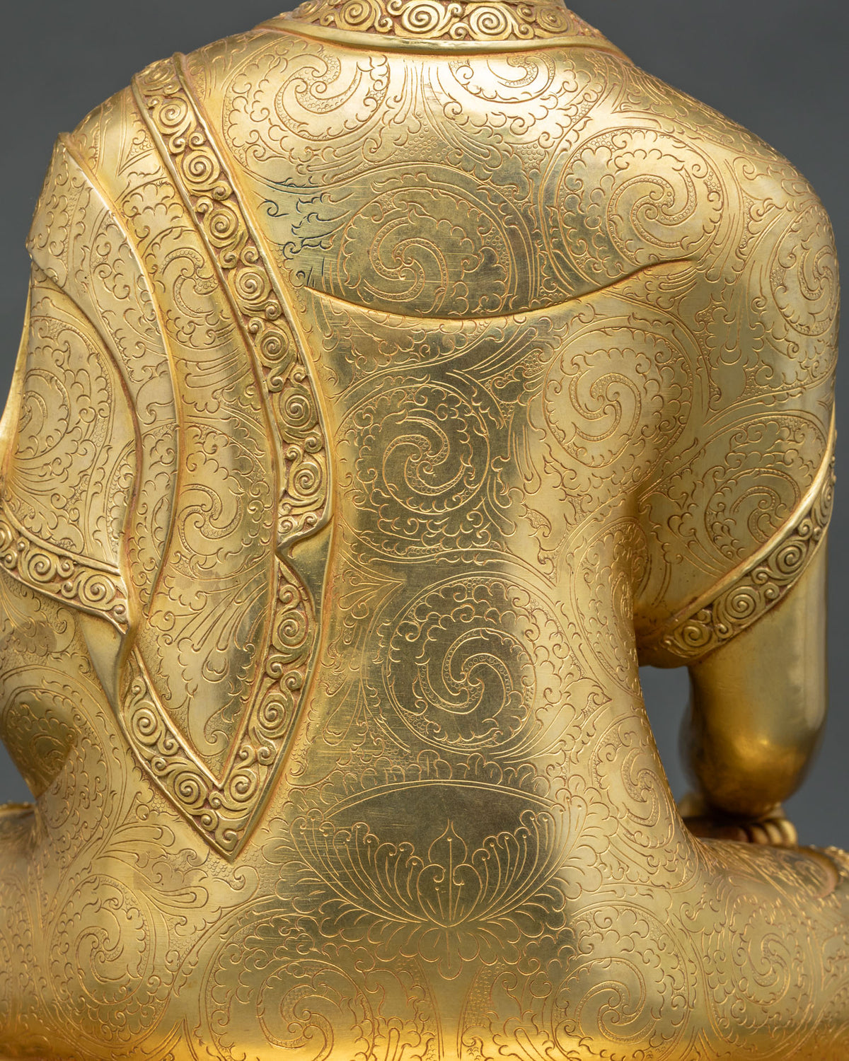 Hand-incised scrollwork and lotus motif on the back of gold fire-gilded Shakyamuni Buddha statue