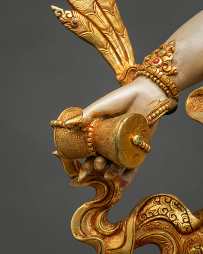 Hand of White Mahakala statue holding a damaru, gilded and set with semi-precious stones