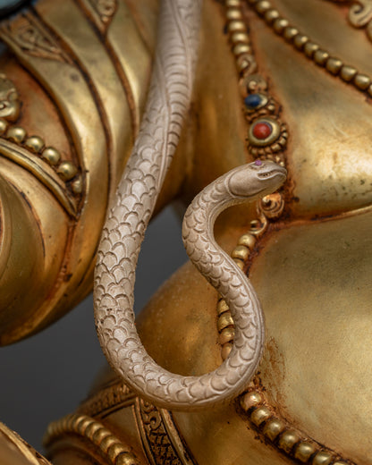 Hand-painted serpent coiling across Dzambhala Statue's shoulder and arm