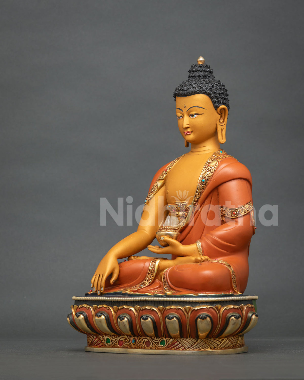 Hand-painted Shakyamuni Buddha statue holding an alms bowl, angled side view from Nepal