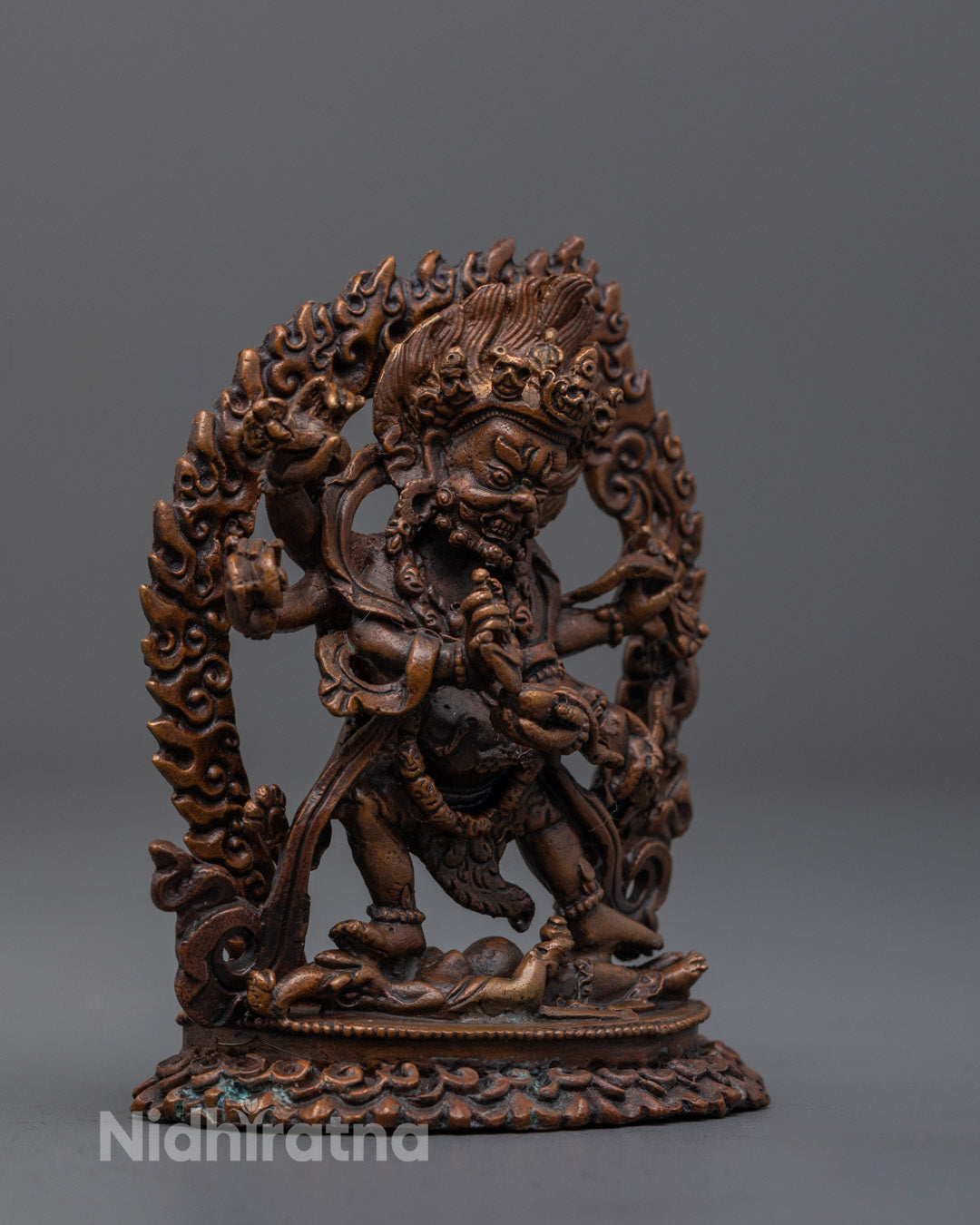 hand-painted Six-Armed Mahakala statue with symbolic implements and oxidized finish