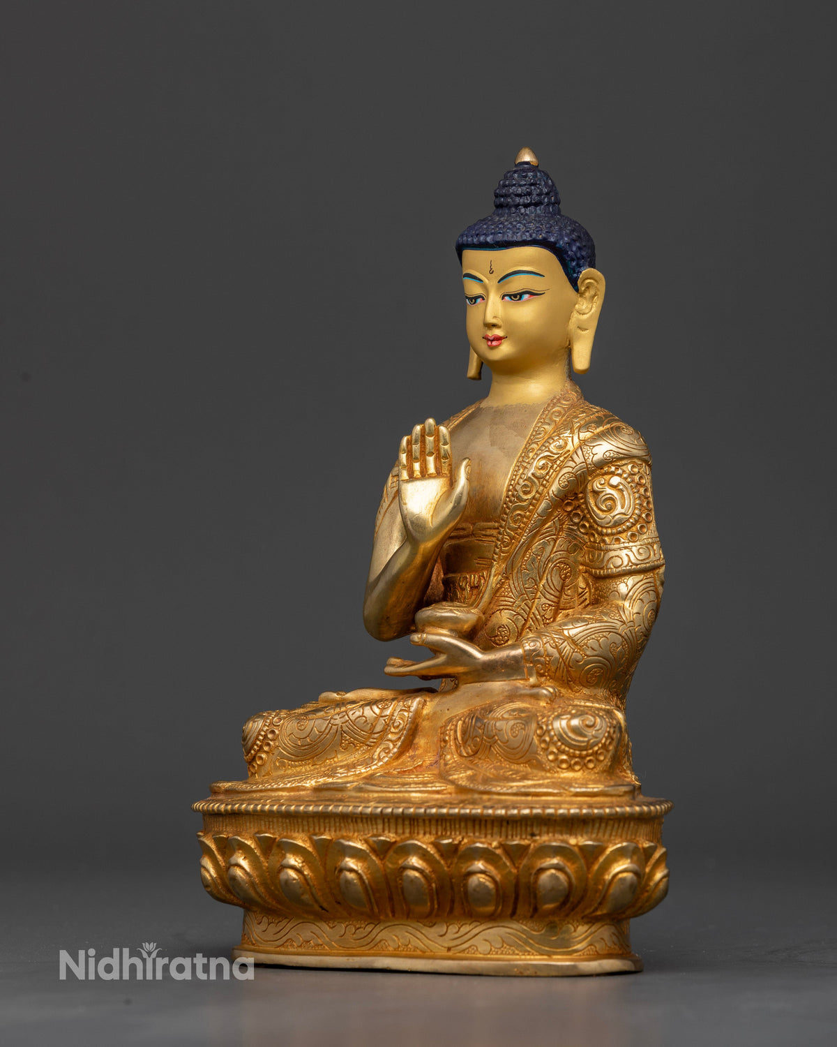 Handcrafted Amoghasiddhi Buddha Statue from Patan Nepal with gold-fire gilded body.
