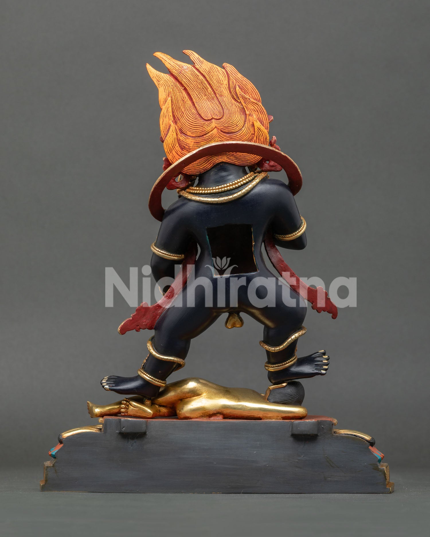 Handcrafted Black Dzambhala wealth god statue back view showing Himalayan ritual artwork details