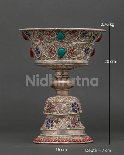Handcrafted Buddhist butter lamp from Patan Nepal with silver plated filigree and gemstones.