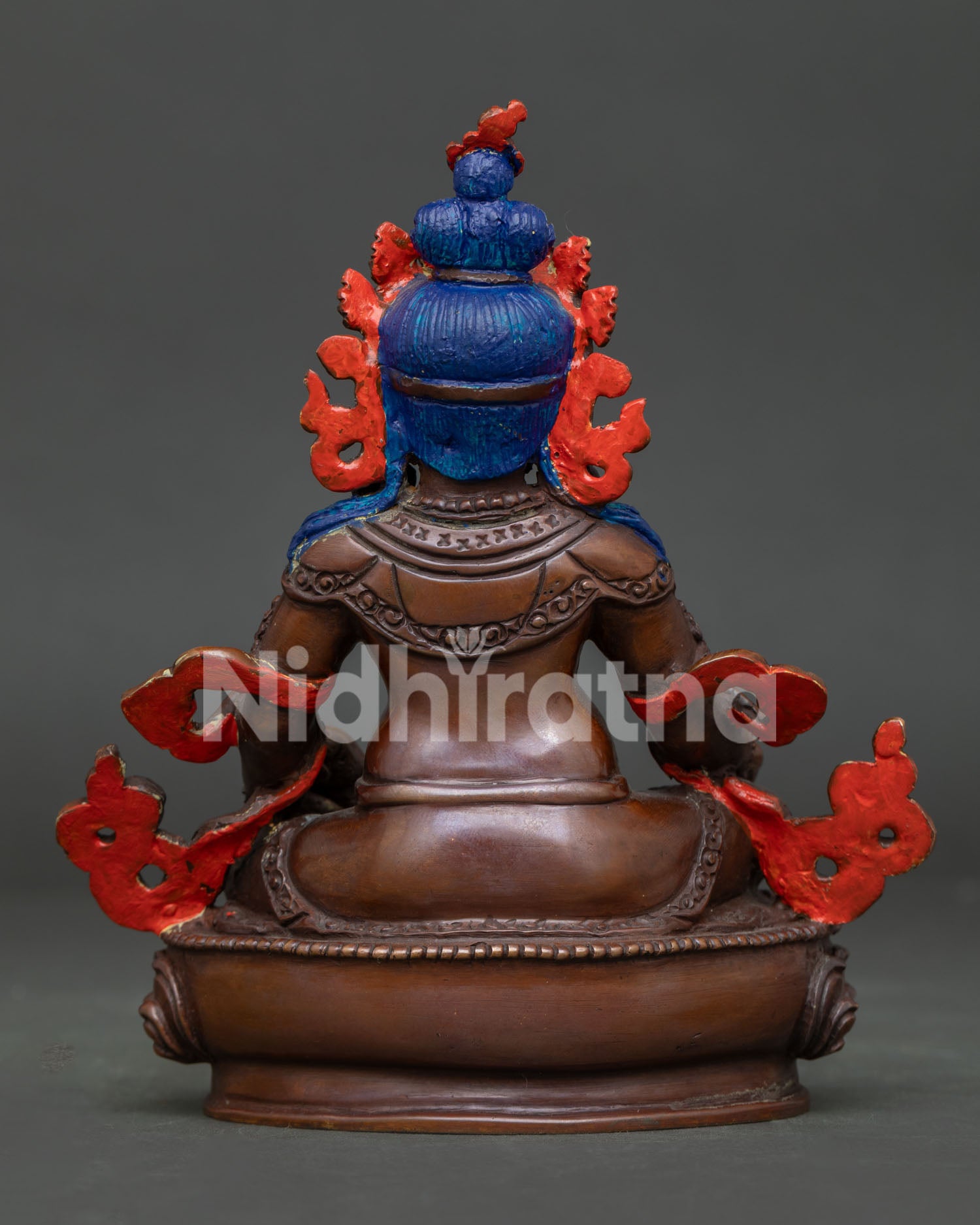Handcrafted Buddhist wealth deity featuring Dzambhala seated on a lotus pedestal with intricate details