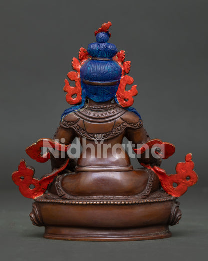 Handcrafted Buddhist wealth deity featuring Dzambhala seated on a lotus pedestal with intricate details