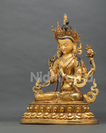 Handcrafted Chenrezig statue angled view showing four arms and gold fire-gilded copper finish