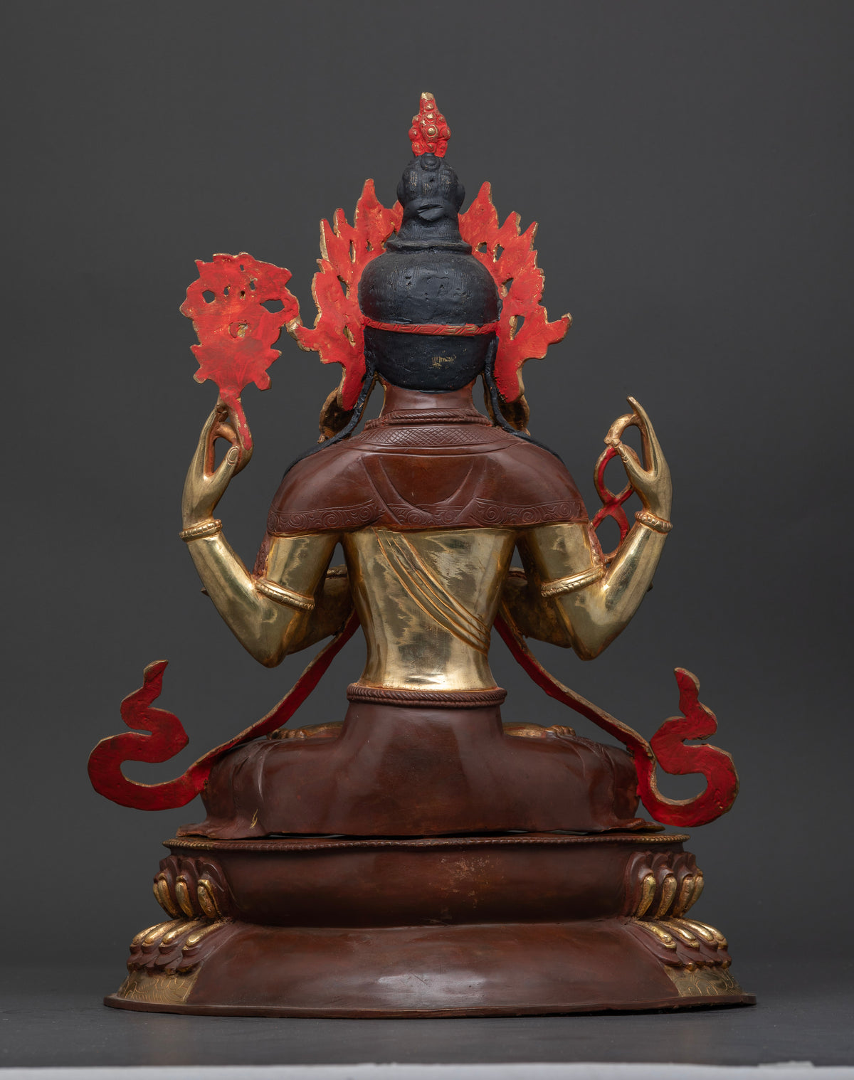 Handcrafted Chenrezig statue from nepal featuring intricate newari metalwork oxidized copper and gold gilding.