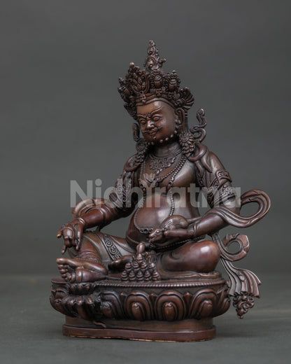 Handcrafted Dzambhala statue from Nepal on lotus pedestal with Chintamani jewel.
