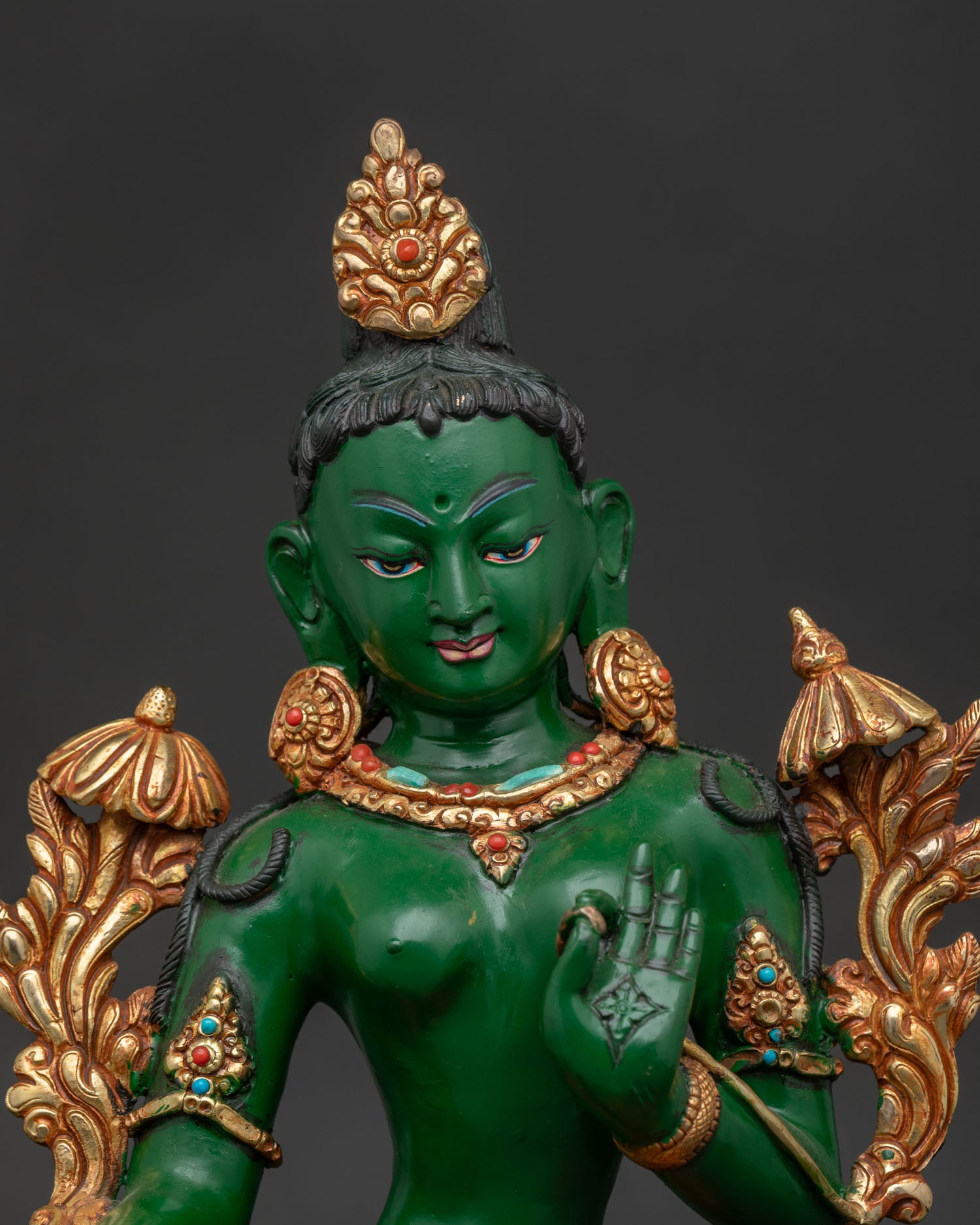 Handcrafted Green Tara Buddhist statue showing intricate copper carving close up