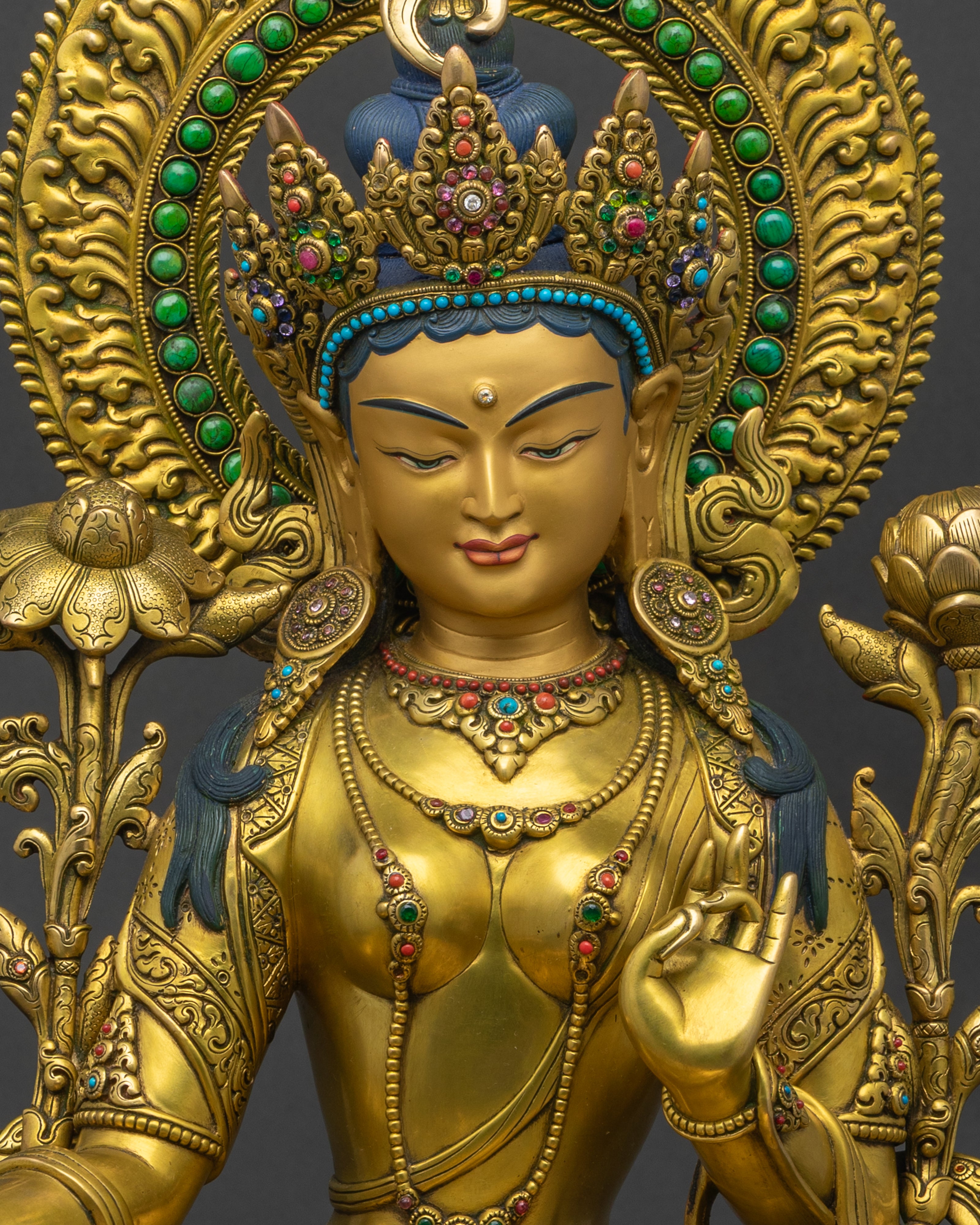 Handcrafted Green Tara closeup: serene face, jeweled crown, semi-precious stone details