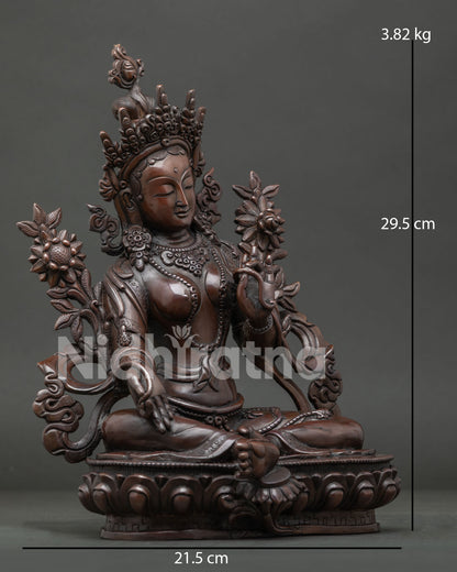 Handcrafted Green Tara Statue with extended right leg and sacred blue utpala lotus.