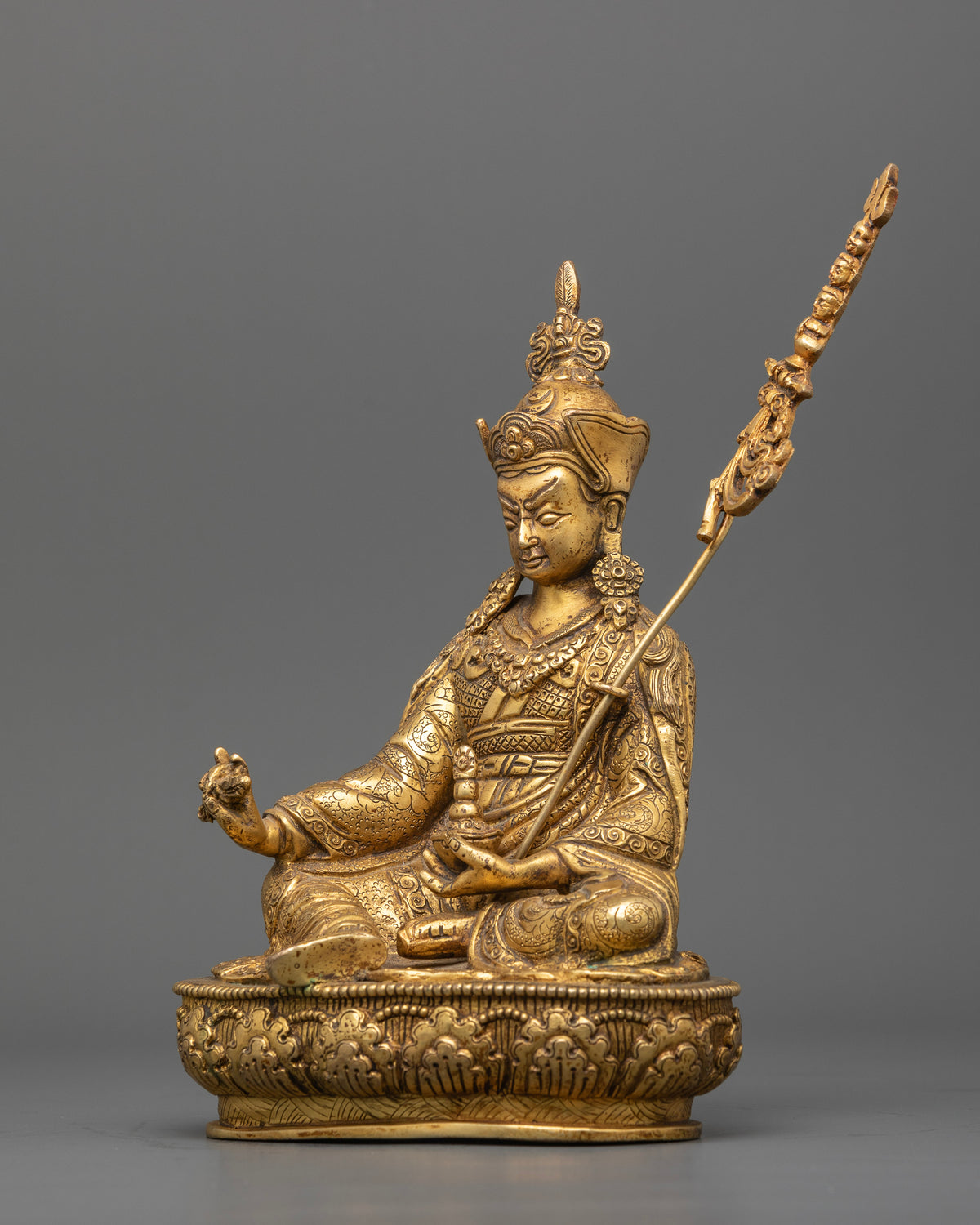 Handcrafted Guru Rinpoche statue with ornate lotus hat and floral motif robes.