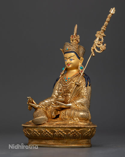 Handcrafted Guru Rinpoche statue with royal garments and floral motifs.