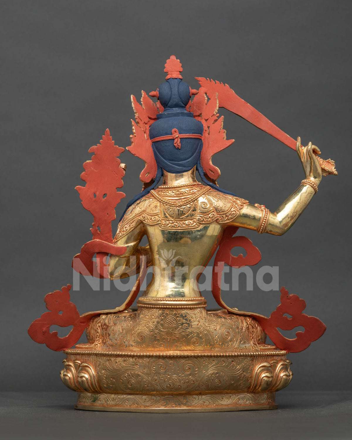 Handcrafted manjushri statue with floral motif silk garment and intricate newari metalwork